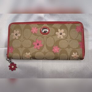 Coach Signature Daisy Floral long zip-around wallet with a beige canvas body